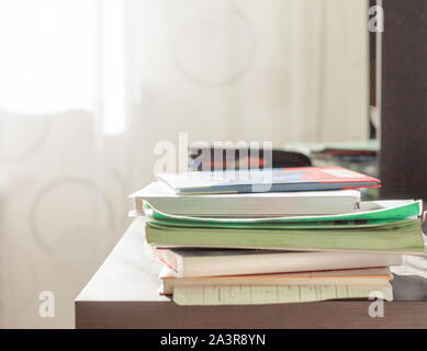 notebooks and textbooks in a mess on the student's Desk Stock Photo