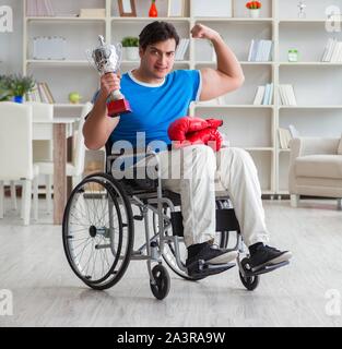 The disabled boxer at wheelchair recovering from injury Stock Photo