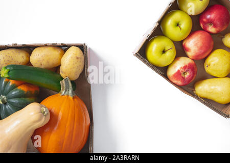 Fruits and Vegetables. Pumpkin, squash, potatoes, zucchini, pears, and apples in container close up, top view, isolated on white with copy space Stock Photo