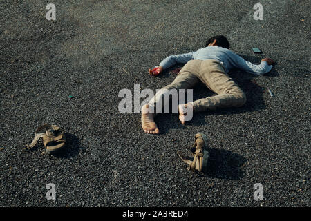 Concept of Crime scene , victim dead body laying on Road. Stock Photo