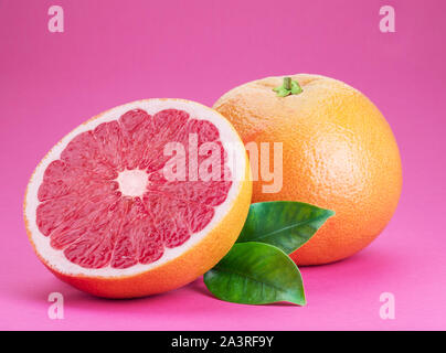 Grapefruit and grapefruit slice isolated on pink background. Stock Photo