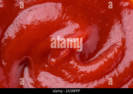 Red tasty tomato ketchup puddle close-up. Stock Photo