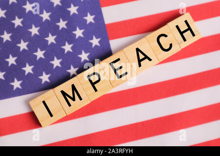 Concept of US politics, Impeachment showing with US flag with Impeach in wooden letters Stock Photo