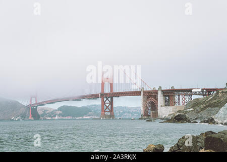 View of Golden Gate Bridge in the fog from the near beach Stock Photo