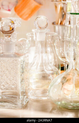Empty decanters with wine glasses in the sunlight. Stock Photo