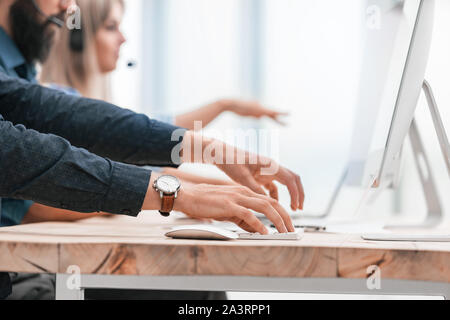 close up. employees work on computers in the office. Stock Photo
