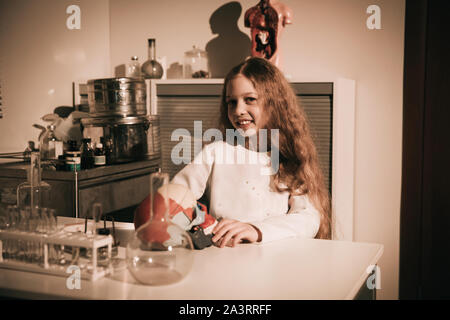 teenage girl conducting research in the school laboratory. Stock Photo