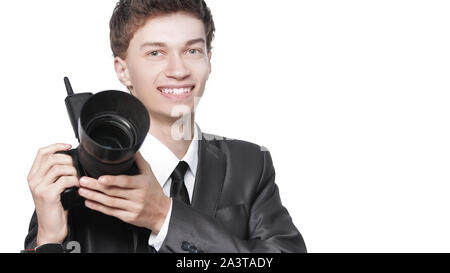 Portrait of young handsome photographer holding the camera Stock Photo