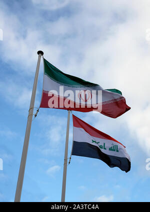 National flags of Iran and Iraq waving in the wind Stock Photo