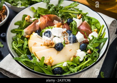 Green salad with leaves, fruit and jamon. Stock Photo