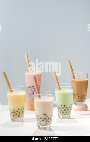 https://l450v.alamy.com/450v/2a3tef0/five-glasses-of-healthy-milky-boba-or-bubble-tea-flavored-with-fresh-fruit-and-chocolate-and-served-with-traditional-wide-straws-2a3tef0.jpg