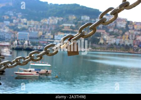 Alanya Harbour in early Spring before the new season starts. Boats are being refurbed & lovers attach locks to the harbour barriers to show their love Stock Photo