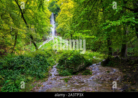 Germany, Beautiful huge 37m high waterfall of climatic spa region bad urach in swabian jura nature landscape, a magical waterfall in green forest scen Stock Photo