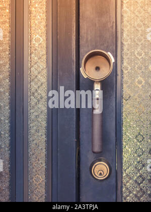 An old coffee brass measuring spoon make as a handle for open and close a  door at the coffee shop Stock Photo - Alamy