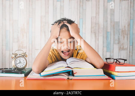 Young asian student screaming and feeling so depressed while studying. Concept of education, stress, depression and tiredness Stock Photo