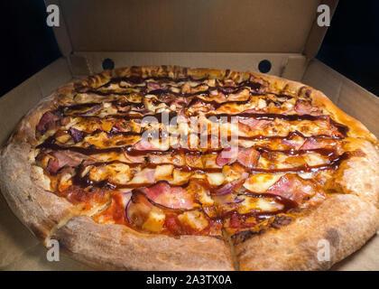 Inside of a Pizza box. Classic pizza in a cardboard box. Wide angle view from above. Pizza delivery, menu. Fast food, crusty dough Stock Photo