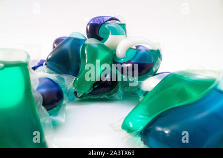 Washing gel capsules stack on white background Dissolving laundry detergent sachets with chemicals for washing clothes Stock Photo