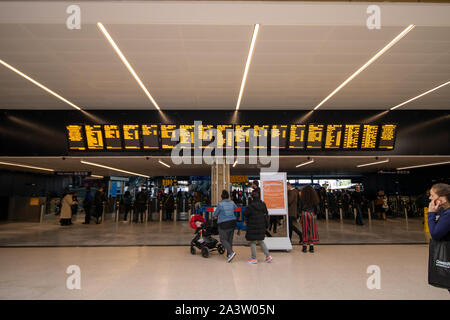 Leeds UK, 9th October 2019: Photo of the Leeds City Train Station located in the Leeds City Centre in West Yorkshire in the UK showing people looking Stock Photo