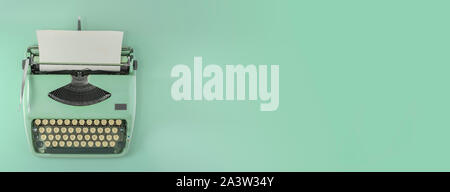 A green vintage typewriter with green background. Stock Photo
