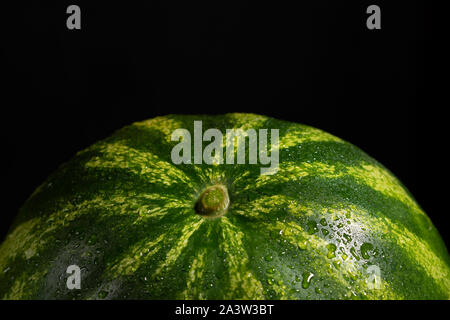 watermelon on black background with water drops Stock Photo