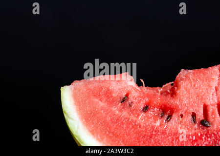 Bit slice of watermelon on black background Stock Photo