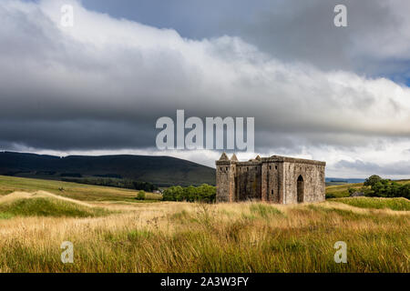 Hermitage Castle is a semi-ruined castle in the Scottish Borders, and has a reputation as one of the most sinister and atmospheric in Scotland. Stock Photo