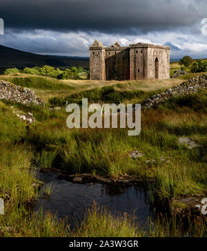 Hermitage Castle is a semi-ruined castle in the Scottish Borders, and has a reputation as one of the most sinister and atmospheric in Scotland. Stock Photo