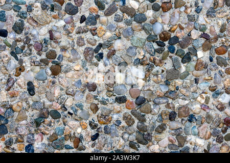 Wall made of small colorful sea stones Stock Photo