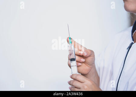 Female doctor hands with syringe, doctor preparing injection medicine, Stock Photo