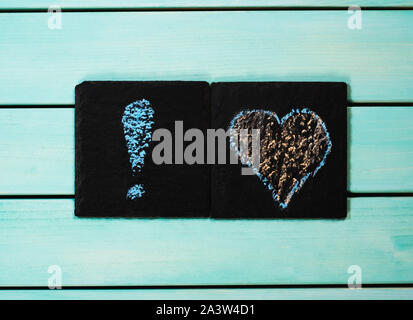 Heart and exclamation mark drawn with chalk, blue wooden background, love concept Stock Photo