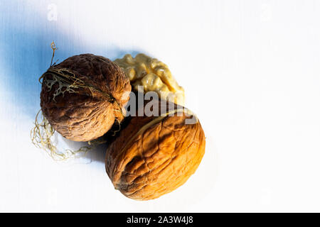 Walnuts on white wooden table Stock Photo