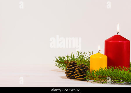 Christmas decoration with two burning candles on white background, winter holidays card with copy space for your text Stock Photo