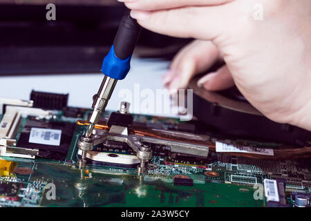 Woman engineer replace cpu from notebook motherboard Stock Photo
