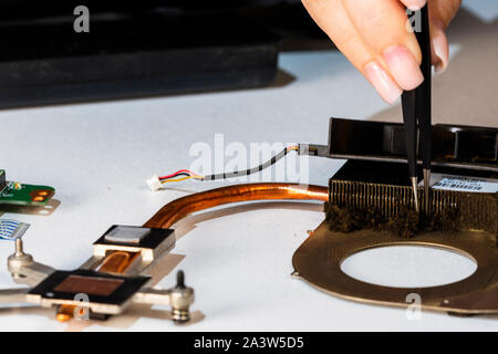 Woman engineer cleaning cooling system from dust Stock Photo