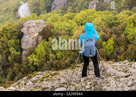 Kalabaka, Greece. A photographer taking pictures of the monasteries of Meteora in the early morning Stock Photo