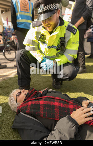 City Airport, London, UK. 10th Oct, 2019. Protesters from environmental campaign group Extinction Rebellion block the road outside London City Airport. A big police presence and numerous arrests. Penelope Barritt/Alamy Live News