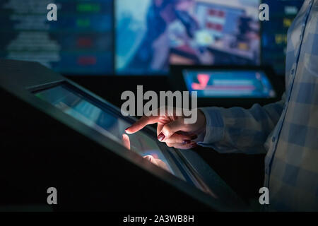 Woman using multimedia touchscreen display of interactive kiosk Stock Photo