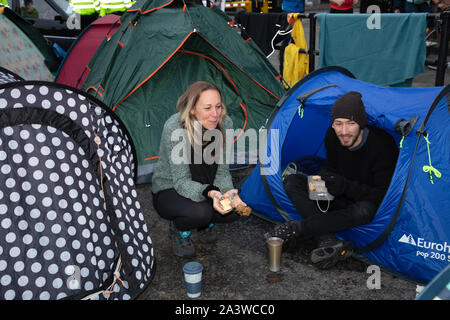 London, UK. 9th October 2019. Protesters camping and waking up on the road near Nelson Column, Trafalgar Square, during the Extinction Rebellion two week long protest in London. Credit: Joe Kuis / Alamy News Stock Photo