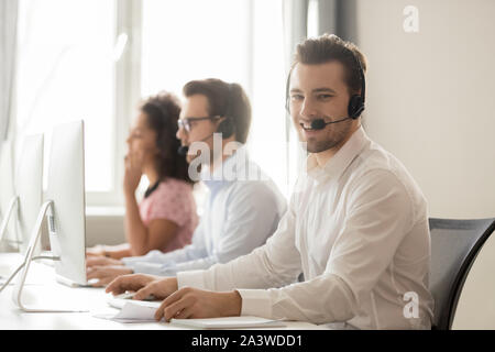 Millennial service phone operator sitting at workplace pose for camera Stock Photo