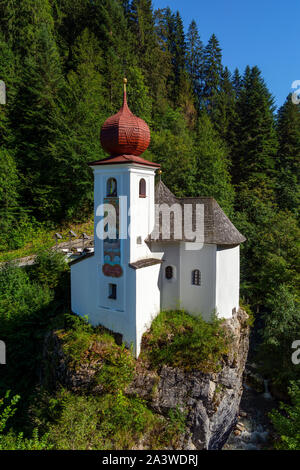 Beautiful small white Saint Mary Church on the rock mountains in Soell ,  in Tirol, Austria Stock Photo