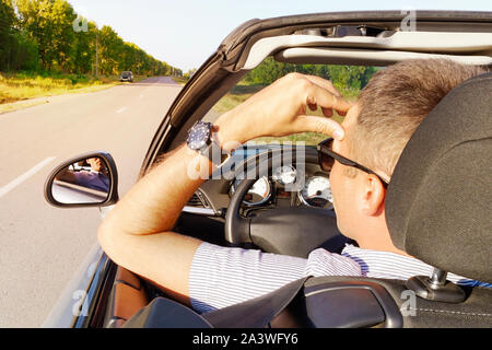 Illness, exhausted, disease, tired for overworked concept. businessman having headache from migraine while he driving car. young man holds his hand ov Stock Photo