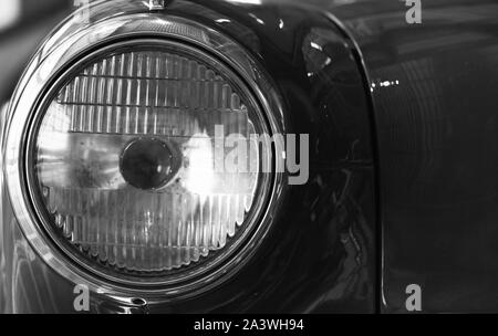 Vintage round car headlight. Old timer details. Close up black and white photo with soft selective focus Stock Photo