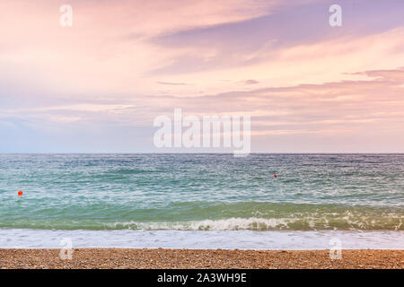 Empty beach at early morning, natural  background photo. Summer landscape with sandy sea coast under colorful cloudy sky Stock Photo