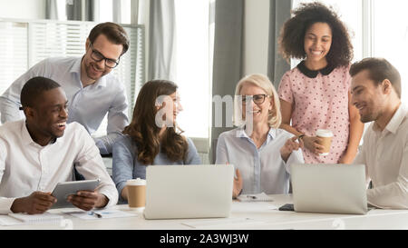 Cheerful multiracial office workers having fun at break in workplace Stock Photo