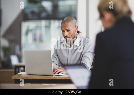 Businessman in a cafÃ© using a laptop Stock Photo