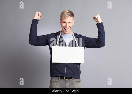 Joyous successful man presenting empty signboard. Stock Photo