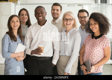 Positive multi racial corporate team posing looking at camera Stock Photo
