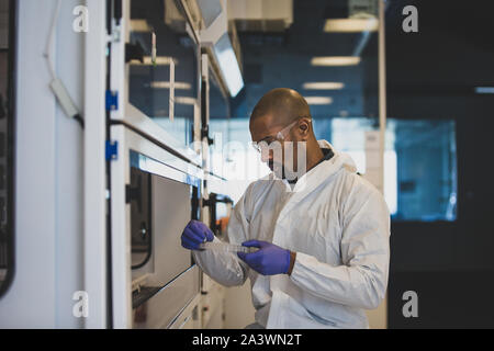 African American scientist looking at sample in a lab Stock Photo
