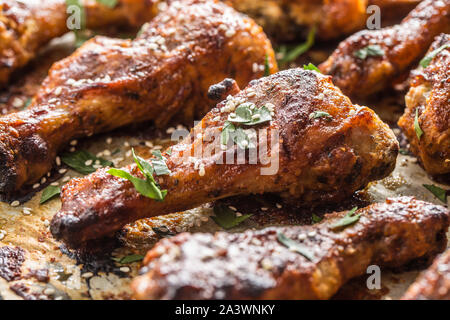 Roasted chicken legs barbecue on baked paper - Close-up Stock Photo