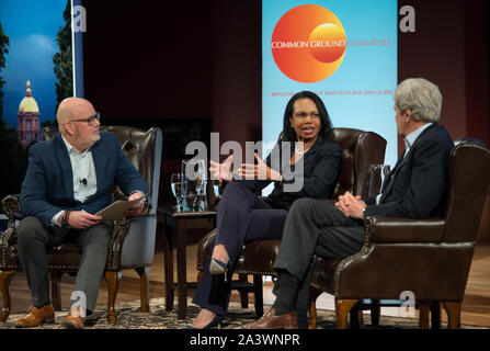 03/19/2019: Notre Dame, IN, USA.  Former U.S. Secretaries of State Condoleezza Rice (Center) and John Kerry (Right) appeared at the Common Ground Committee public forum inside the 900 seat Leighton Concert Hall at the University of Notre Dame.  The event was moderated by Howard LaFranchi (Left) diplomacy correspondent for The Christian Science Monitor.  The forum was cosponsored by BridgeND, The Rooney Center for the Study of American Democracy and the Notre Dame International Security Center. Stock Photo